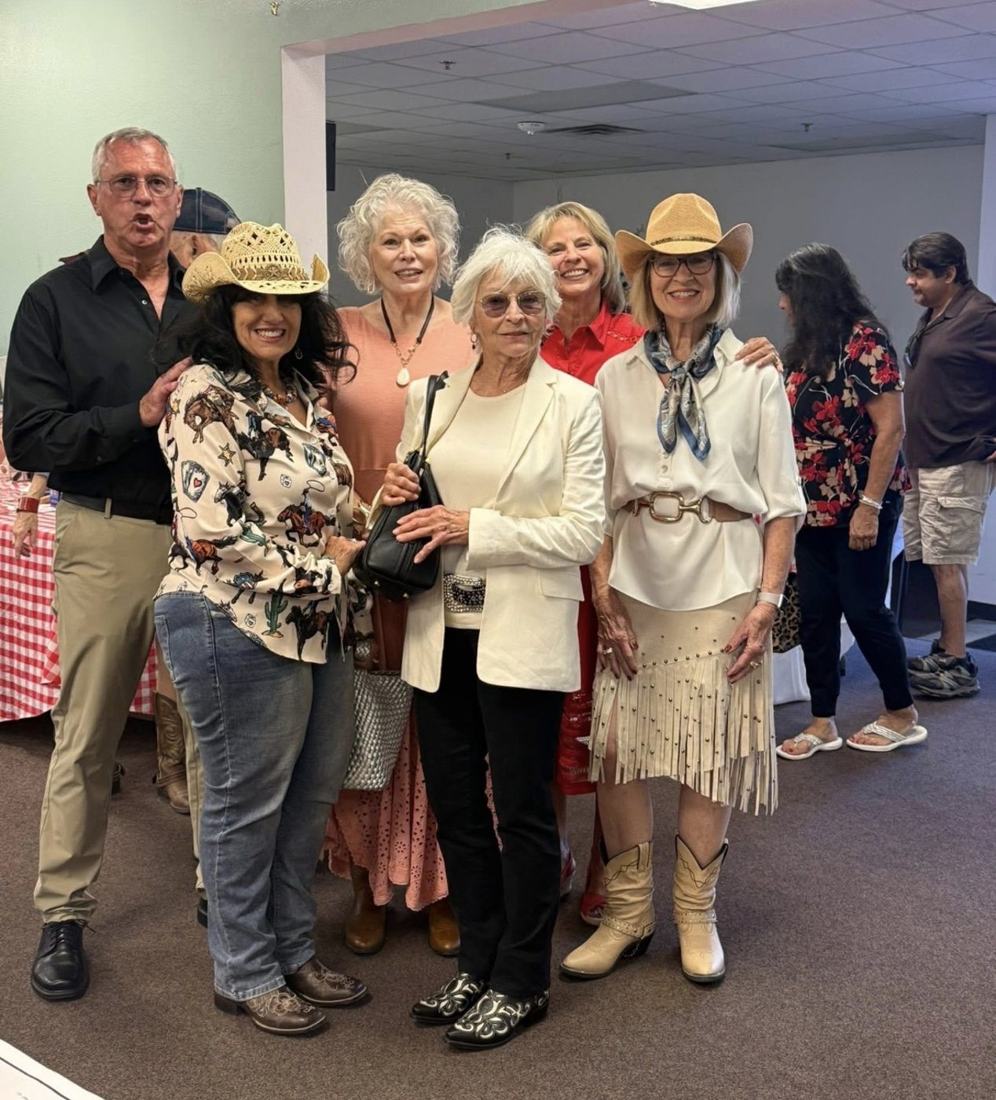 A group of supporters, several wearing cowboy hats, standing together at the event.